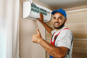 Service technician maintaining heat pumps in Hamilton