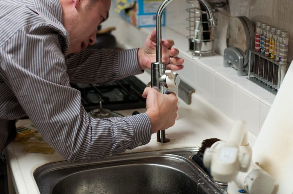 plumber fixing faucet