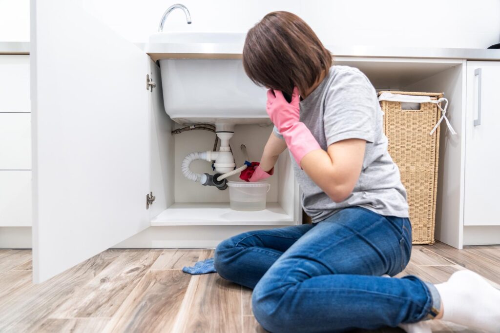 woman calling for help from blocked drain