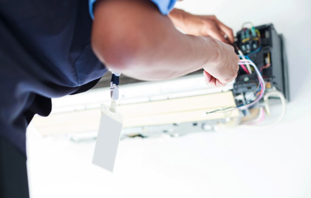 person disassembling and Cleaning Air Conditioner